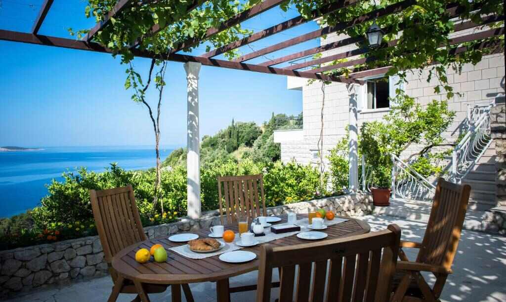 Shaded pergola terrace with sea view at Comfort Zovko
