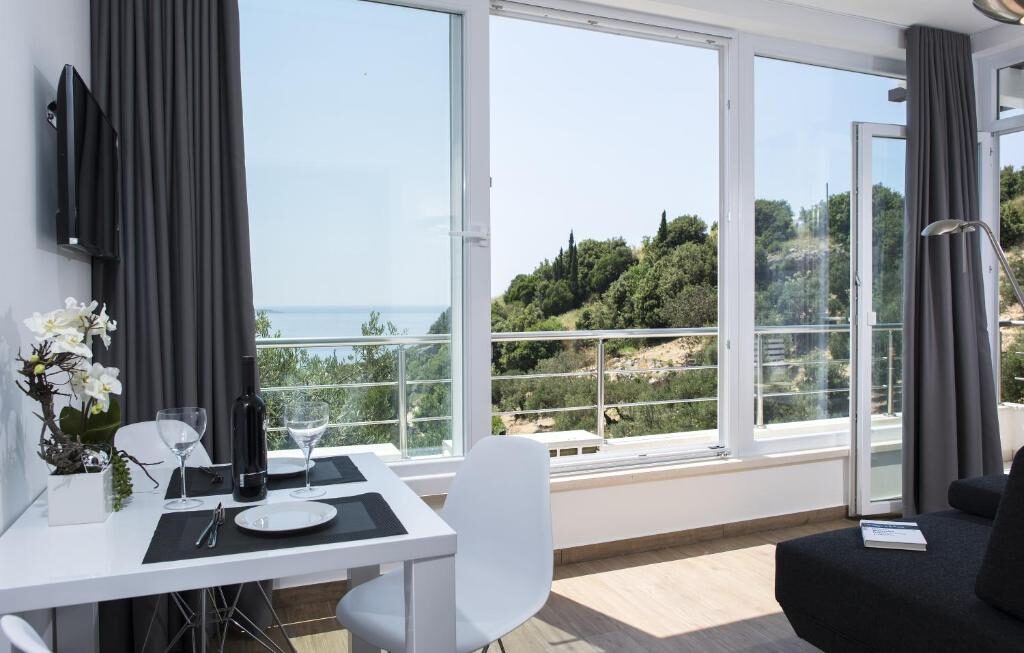 Dining area with large windows and sea view at Comfort Zovko