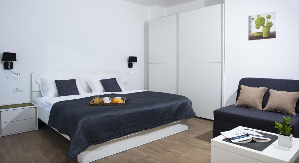 Spacious room with sofa and wardrobe at Comfort Zovko